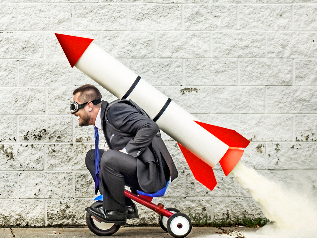 Man on Tricycle with Rocket on Back